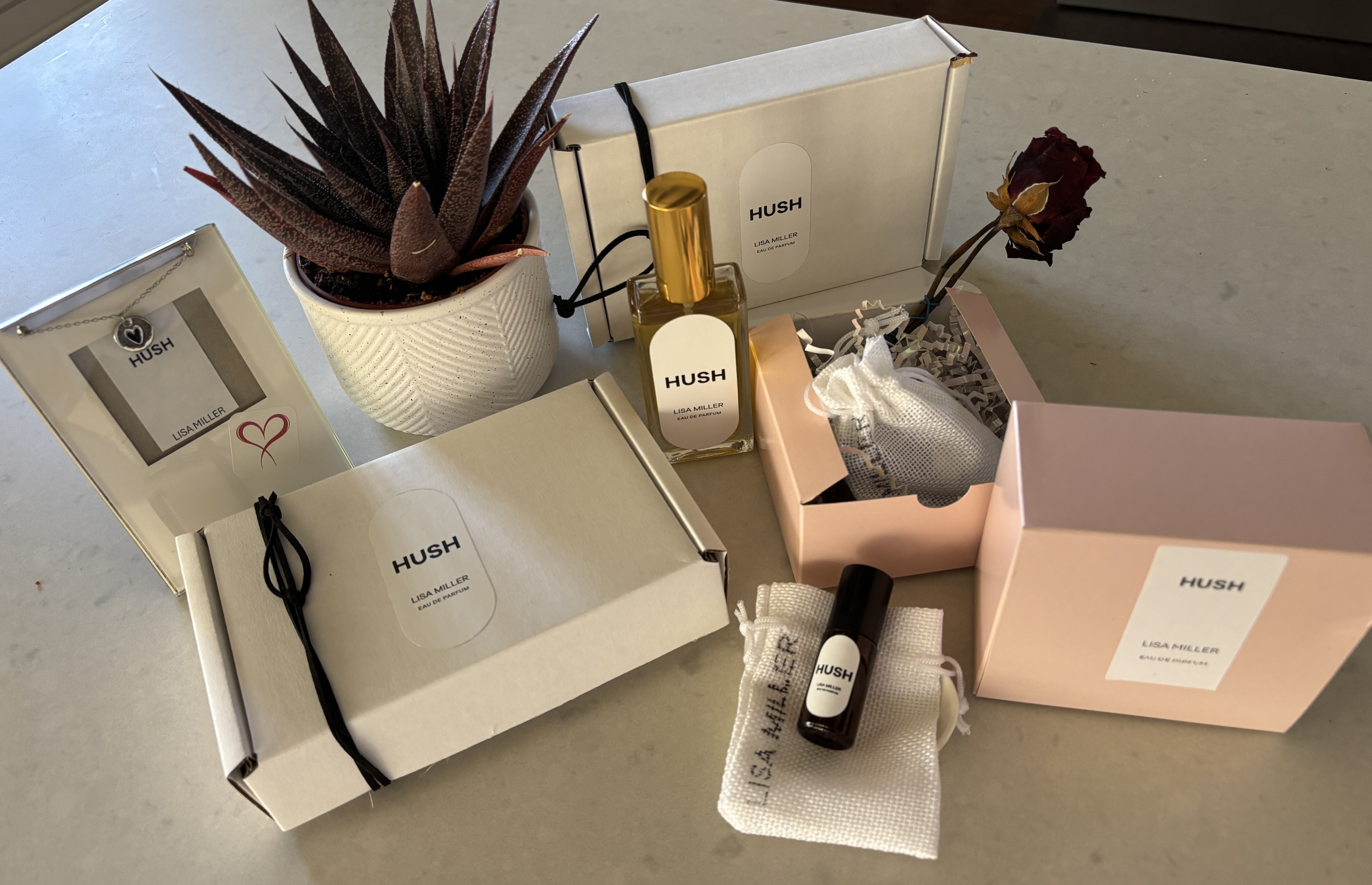 Hush perfume collection — bottle, roller, gift boxes and packaging, necklace and natural details